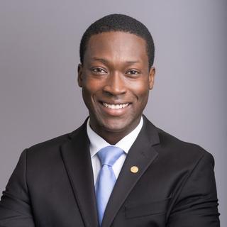George Anderson wearing a suit with a blue tie