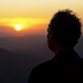 silhouette of a man watching the sunset