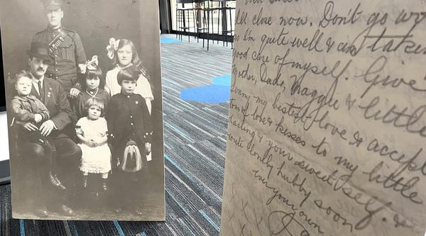A picture of a solider and his family to the left, a copy of a letter in the foreground