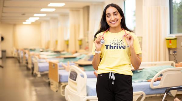 Ashley Sandhu, a Wellness Promoter, in the nursing lab, where she is a student