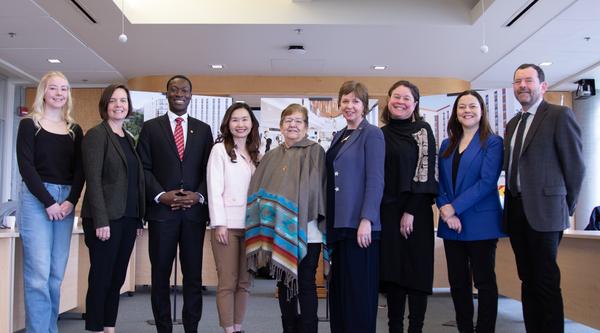 A group poses in the boardroom