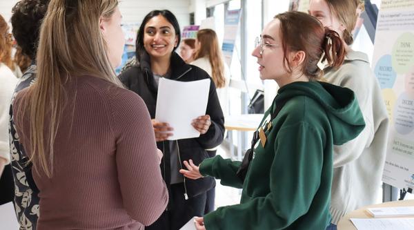 Five students talk to each other at CREATE conference