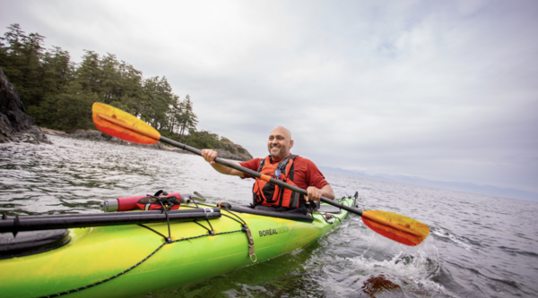 Farhad in a kayak paddling on the ocean