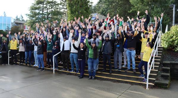 Group photo of people raising their hands in celebration