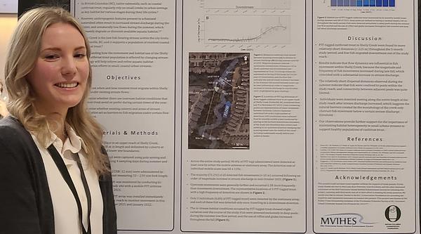 Ally Badger stands in front of a research poster.