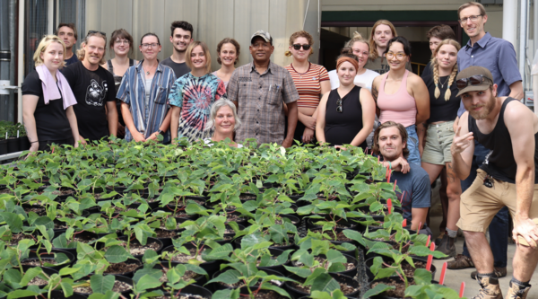VIU Horticulture students in front of plants inside greenhouse