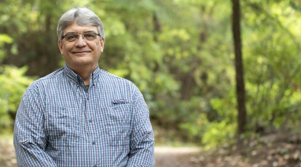 VIU Forestry Professor Bill Beese stands in front of trees.