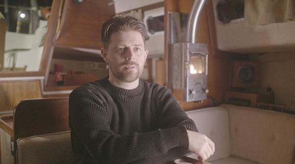 Bryce Casavant sits in the interior of a boat