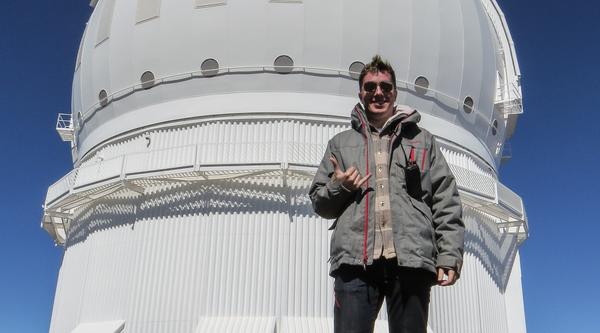 Cam Wipper in front of the Canada-France-Hawaii Telescope