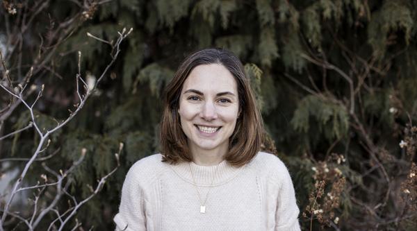 Kimberly Coleman, a woman is standing in front of trees