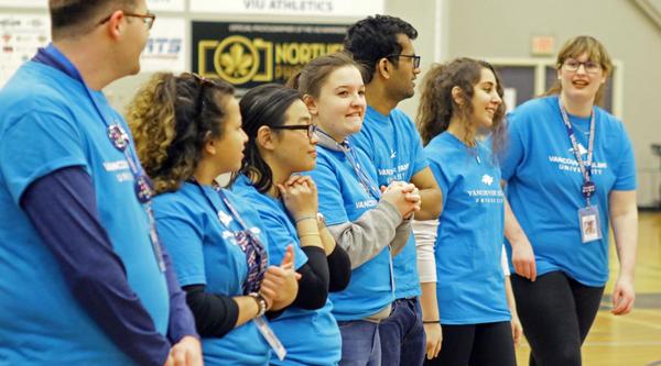 a group of students wearing VIU T-Shirts addresses a crowd