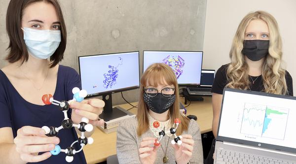 Students and a professor at VIU hold models of molecules in their hands.