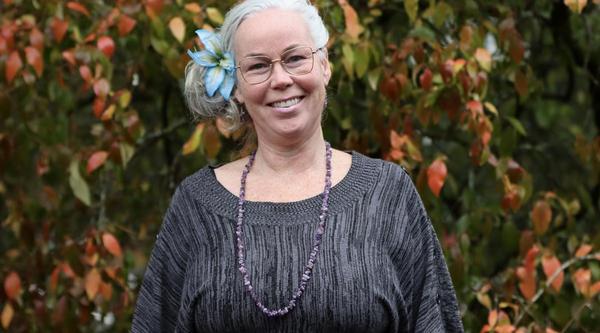 Eliza Gardiner in front of greenery