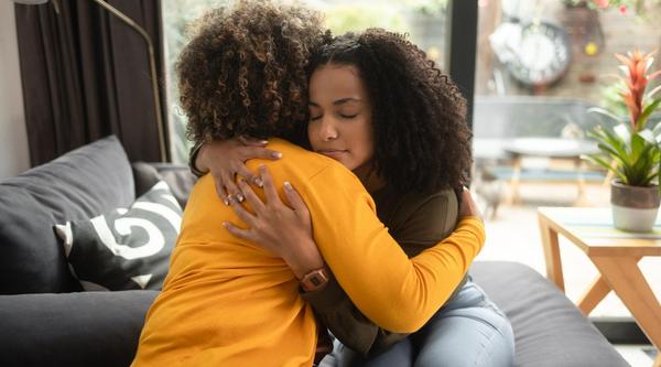 Two women hug