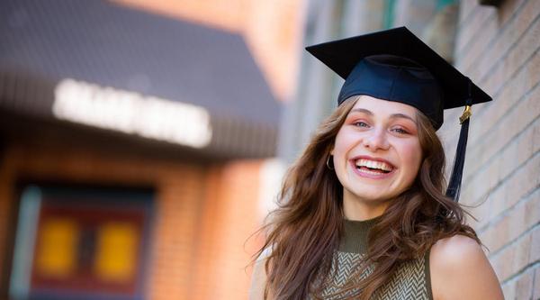 Portrait shot of Lurana wearing a grad cap