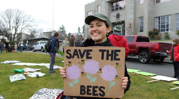 Emma Simard Provencal holding a Save the Bees sign