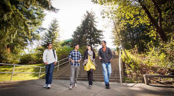 Four students walk down the stairway near the Nanaimo campus Quad.