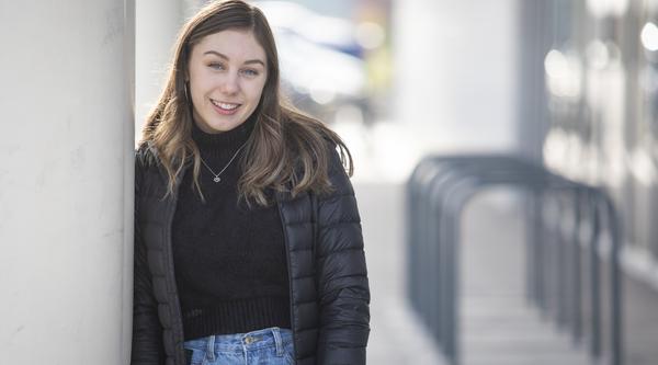 Student posing next to the Health and Science Centre