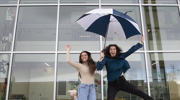 Kayla and Victoria jump in the air
