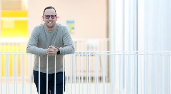 Man leans on railing in VIU's Centre for Health and Science