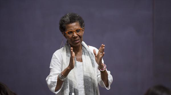 M. NourbeSe Philip stands in the front of a classroom.