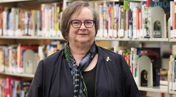 Marni in front of her comic collection