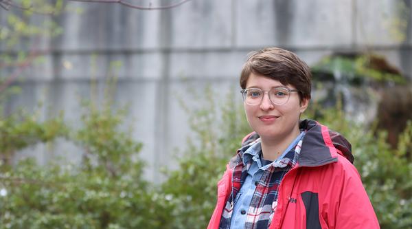 Misha Zvekic stands in a garden at VIU's Nanaimo campus.