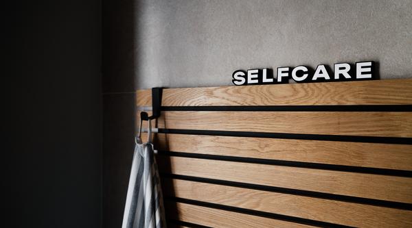 Board with self care written on the top