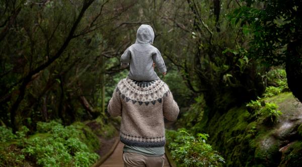 Man with baby in forest