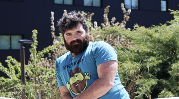 Philip Lawton leaning on railing and looking at the camera