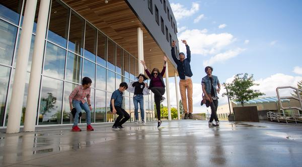 Students jumping outside the Health and Science Centre