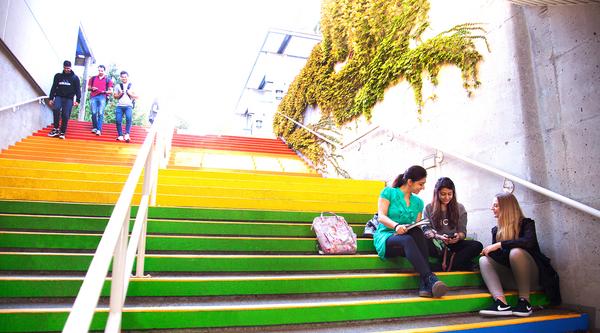 People sitting on rainbow stairs at VIU's Nanaimo campus