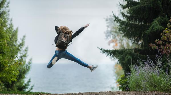 Student jumping in trees