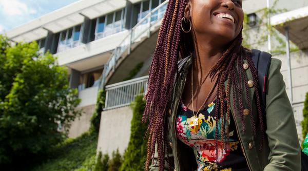 student smiling outside of library