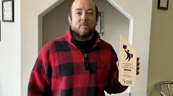 Tyson holds up his Ma Murray award