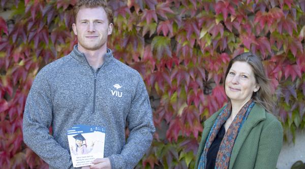 Nathan and Sam in front of vines on a wall
