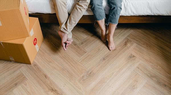 people sitting on a bed with boxes around them