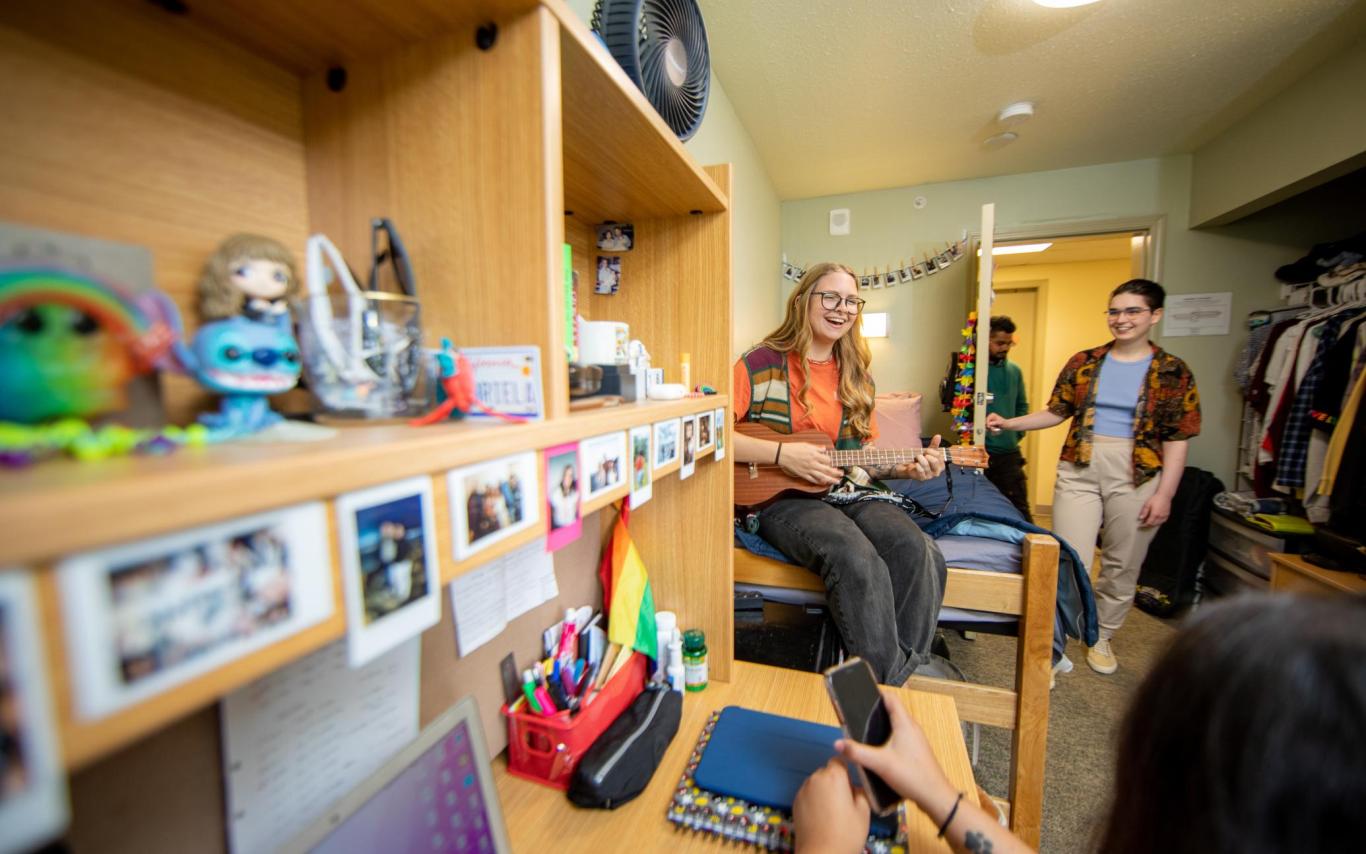 Four students hang out in a dorm