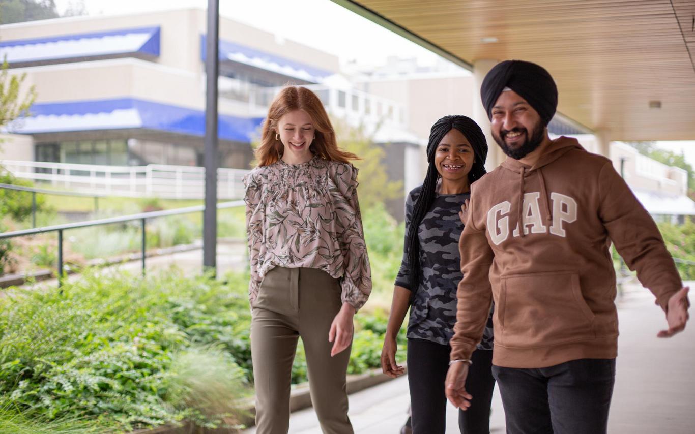 Three students walk by the Health and Science Centre