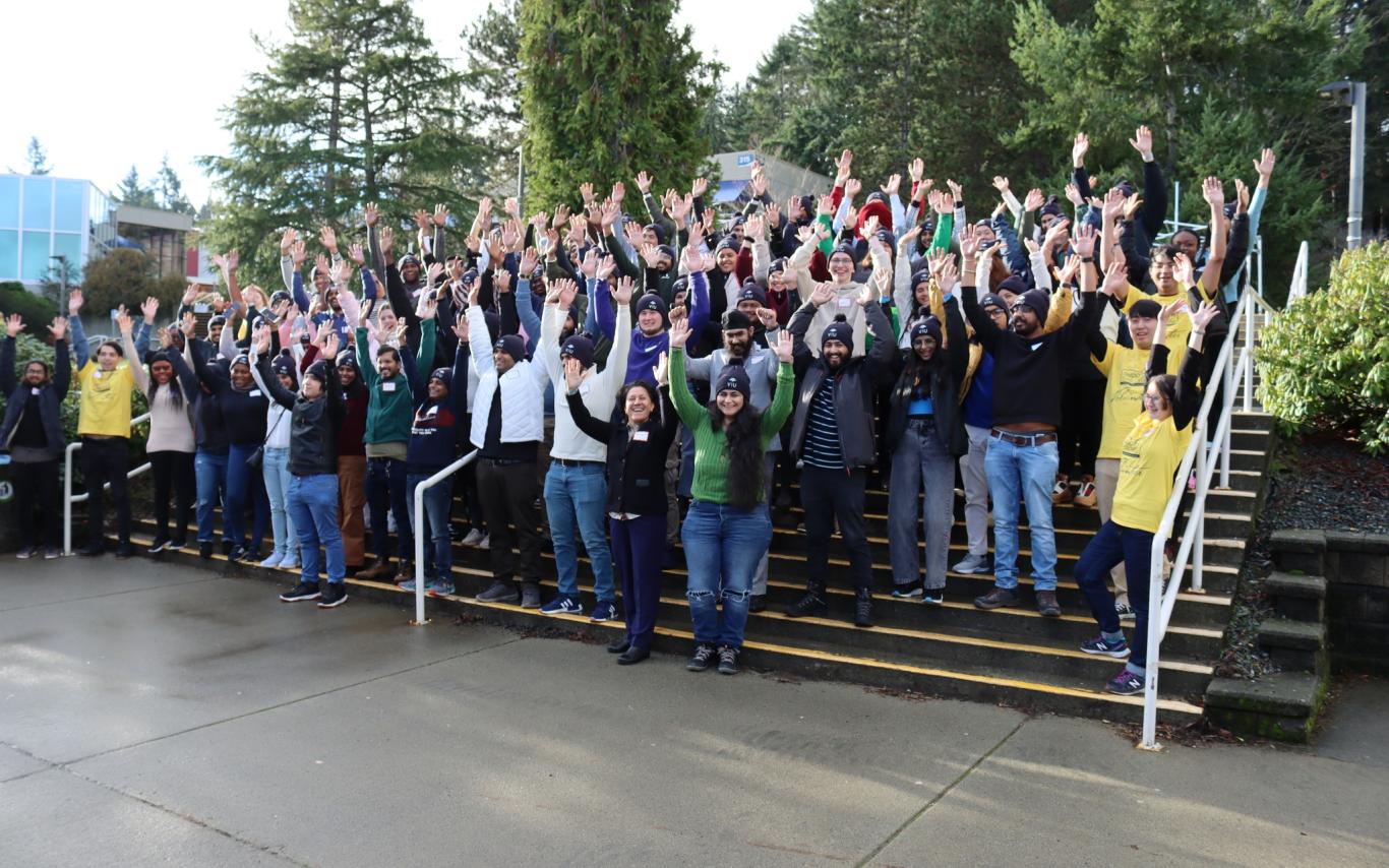 Group photo of people raising their hands in celebration