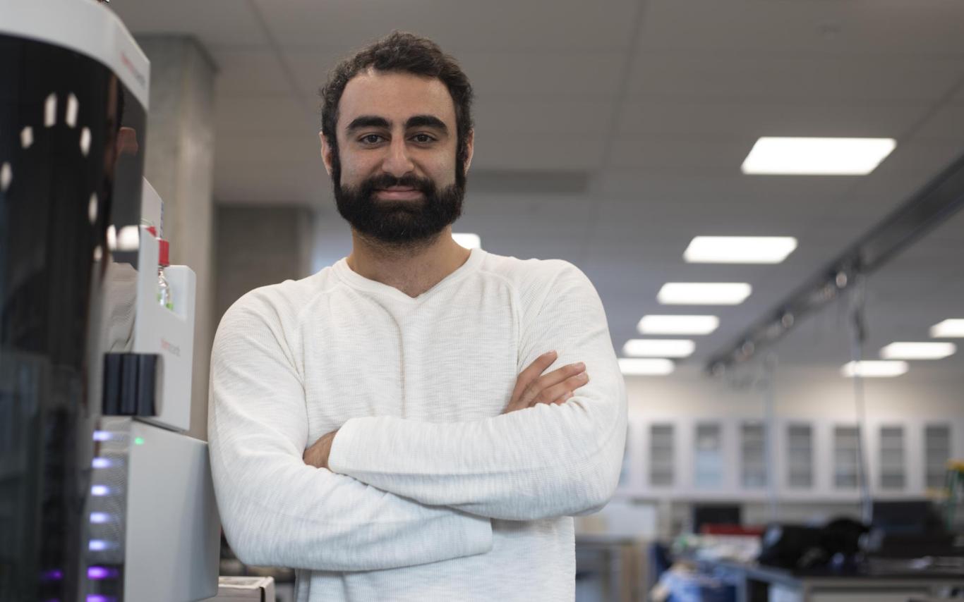Armin Saatchi next to a mass spectrometer on loan to VIU from Thermo Fisher Scientific