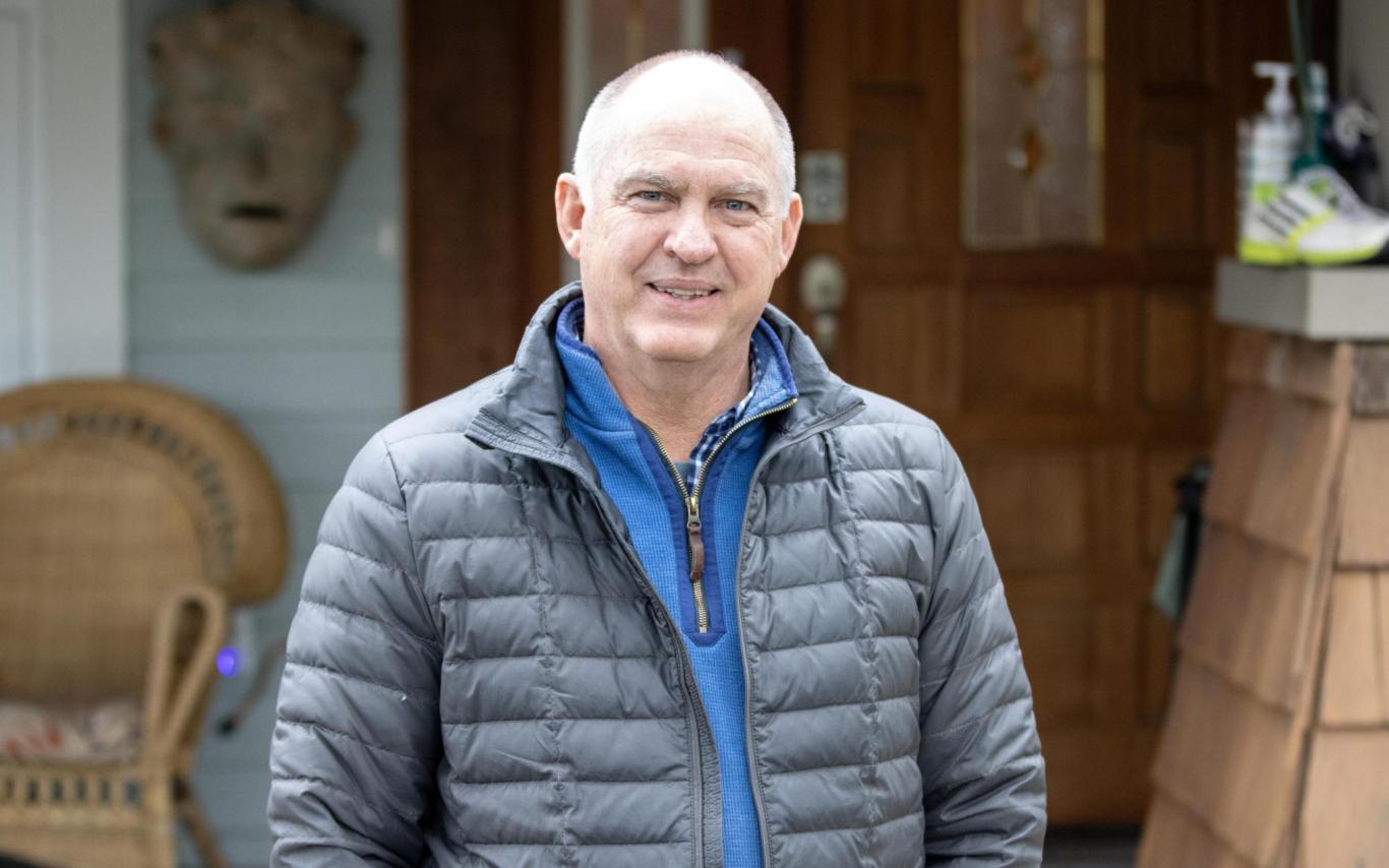 Bruce Barnard stands in front of his house