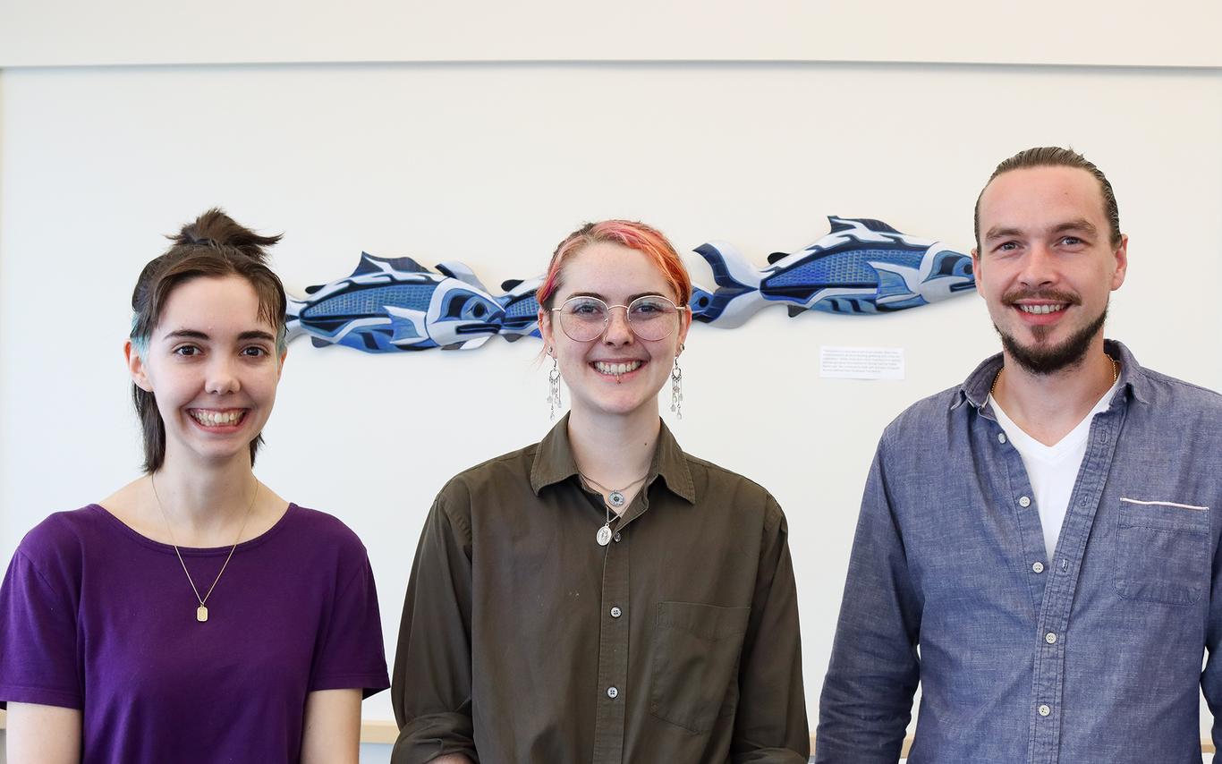 Simon Maguire, Lily Eggert and Trevor Michalchuk stand side-by-side smiling.