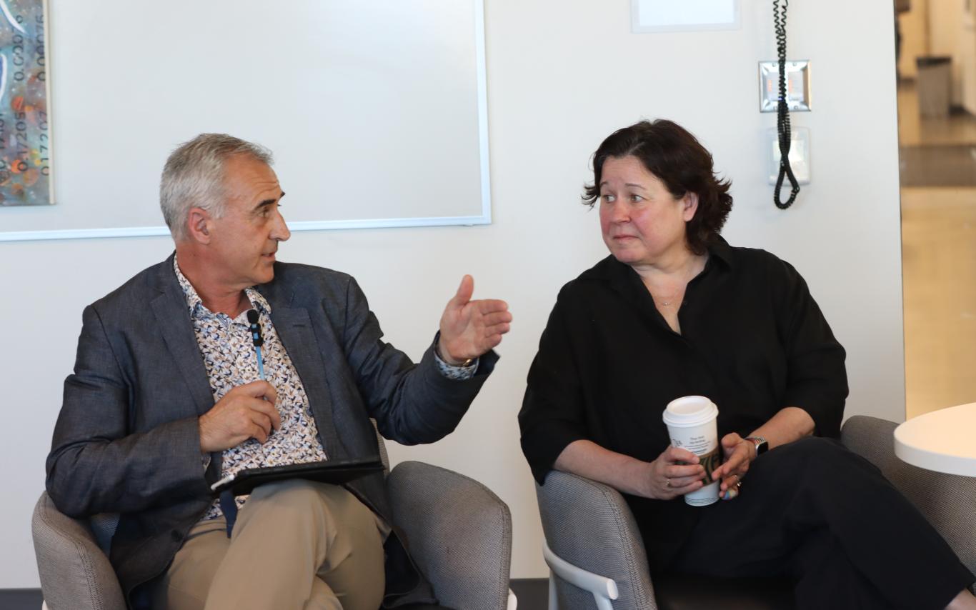 two people seated talk to one another, on the left is VIU Provost and Vice-President Academic Dr. Michael Quinn, on the right is VIU President and Vice-Chancellor Dr. Deborah Saucier