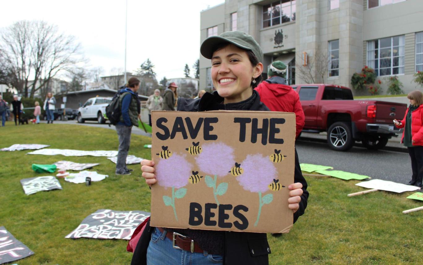 Emma Simard Provencal holding a Save the Bees sign