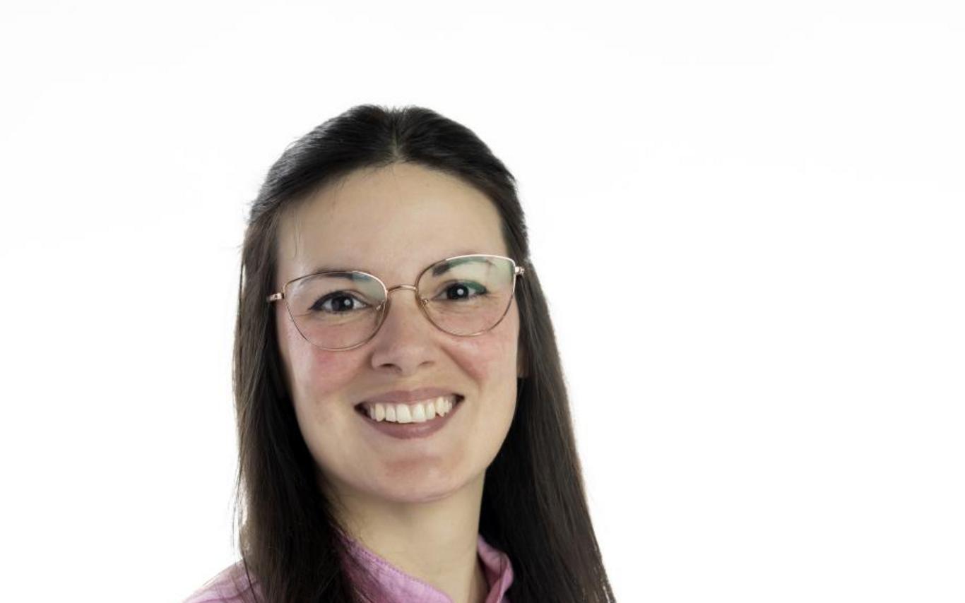Kate Wilson in a baking uniform holding a rolling pin