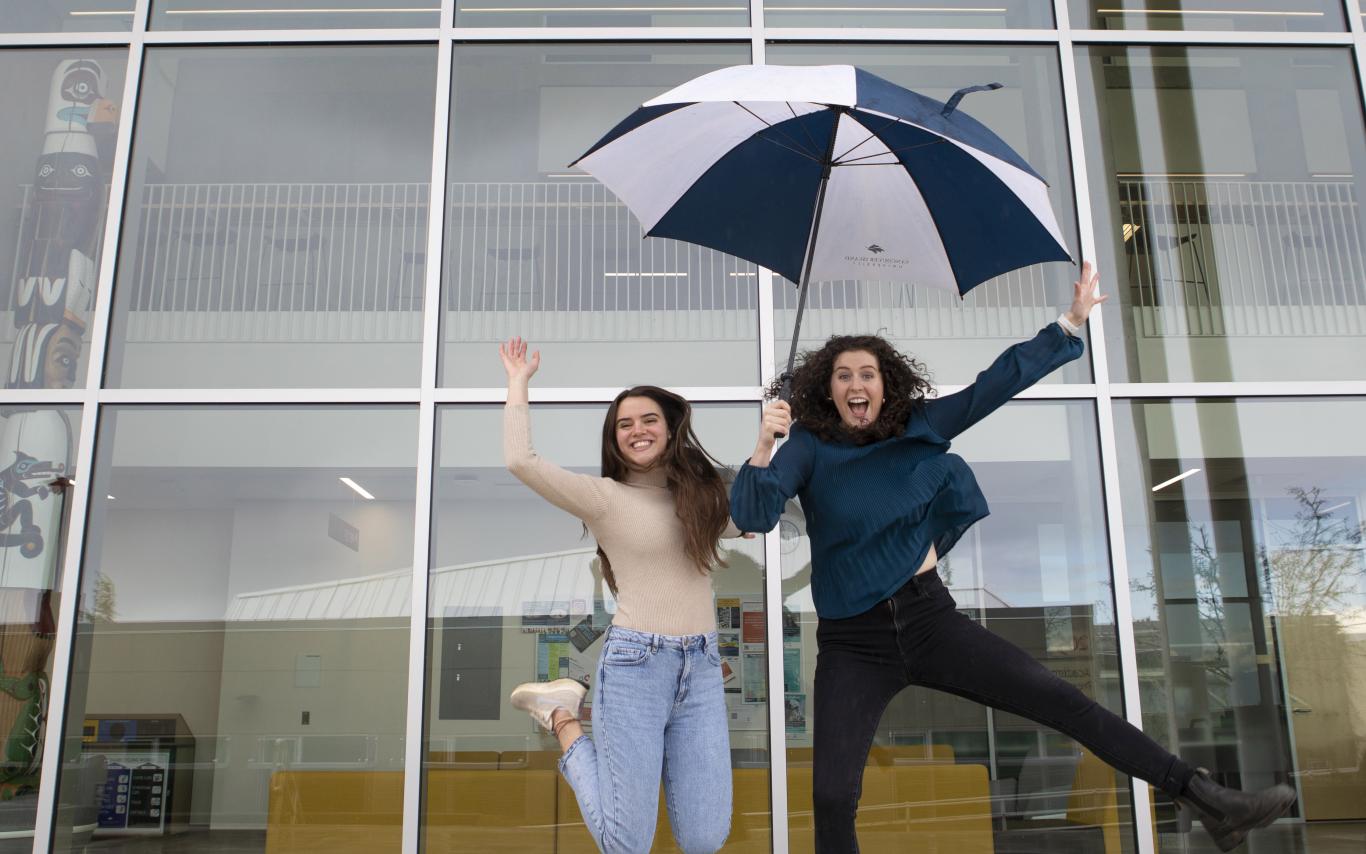 Kayla and Victoria jump in the air
