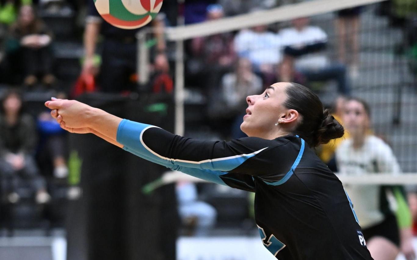 Linea Brickwood gets ready to bump the ball during a Mariners game inside the VIU gym while a crowd watches in the background