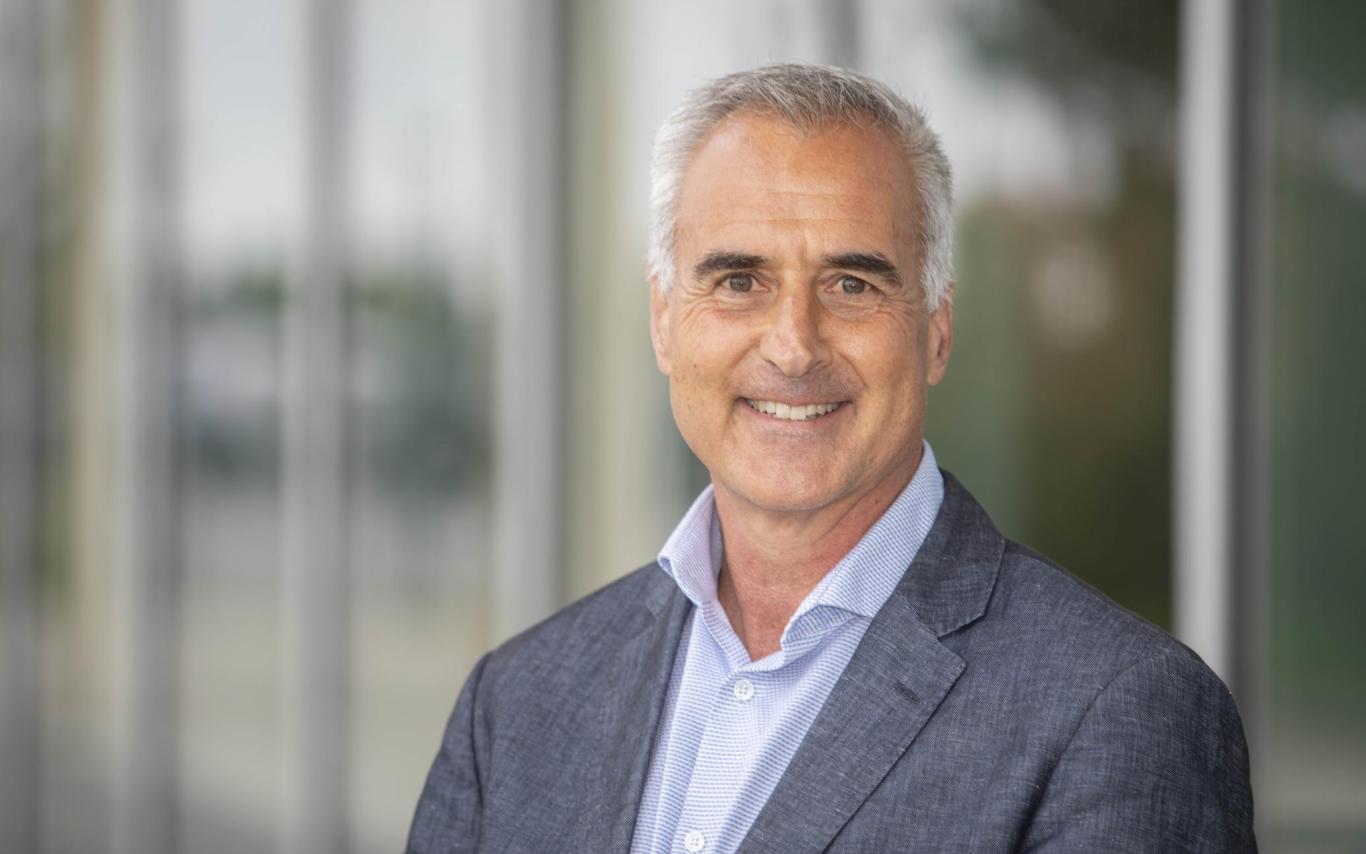 Head shot of Mike Quinn standing in front of the Centre for Health and Science at VIU's Nanaimo campus