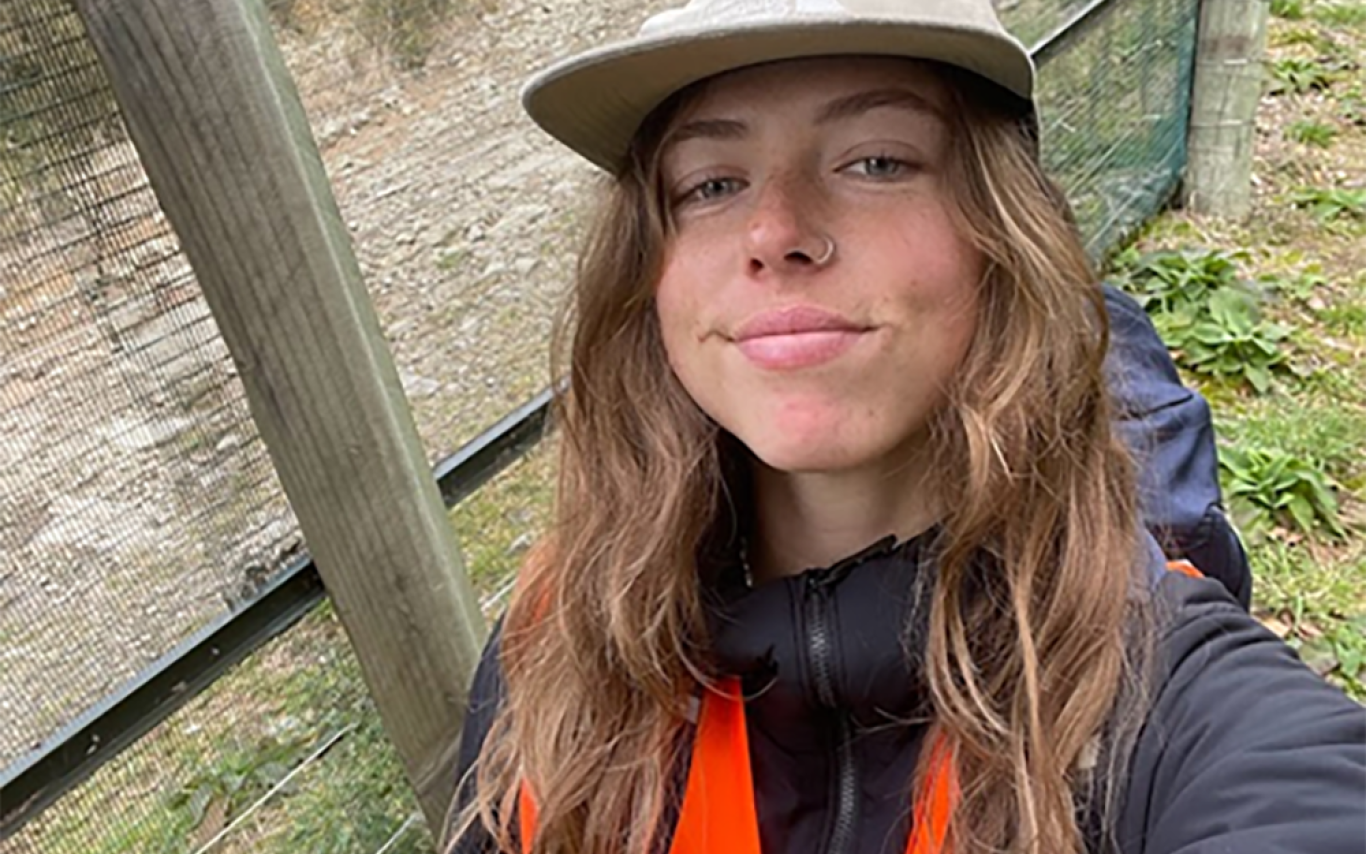 Georgia stands in front of a fence